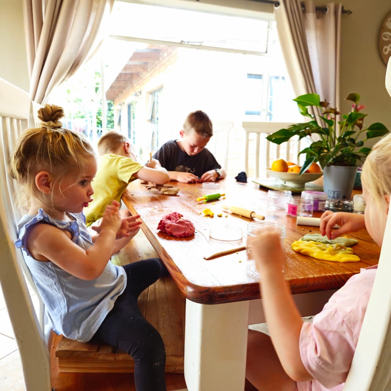 Family playing with playdough together at the table